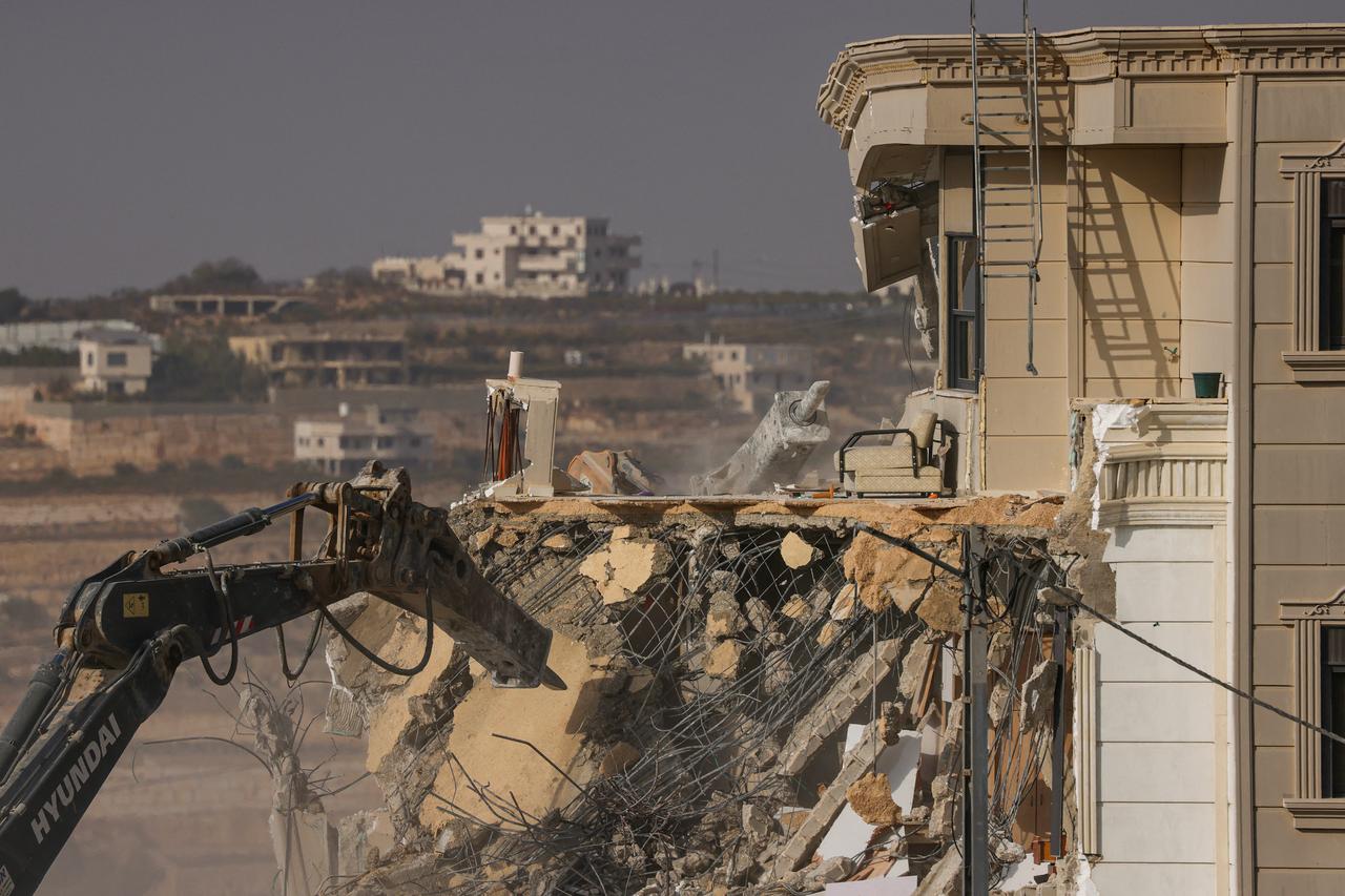 Israeli bulldozers demolish a Palestinian building for the lack of construction permits in the so-called Area C designated by the 1995 Oslo Accords -- occupied Palestinian territory which remains under full Israeli control -- in the Israeli-occupied West Bank city of Hebron on October 23, 2026. (AFP Photo)