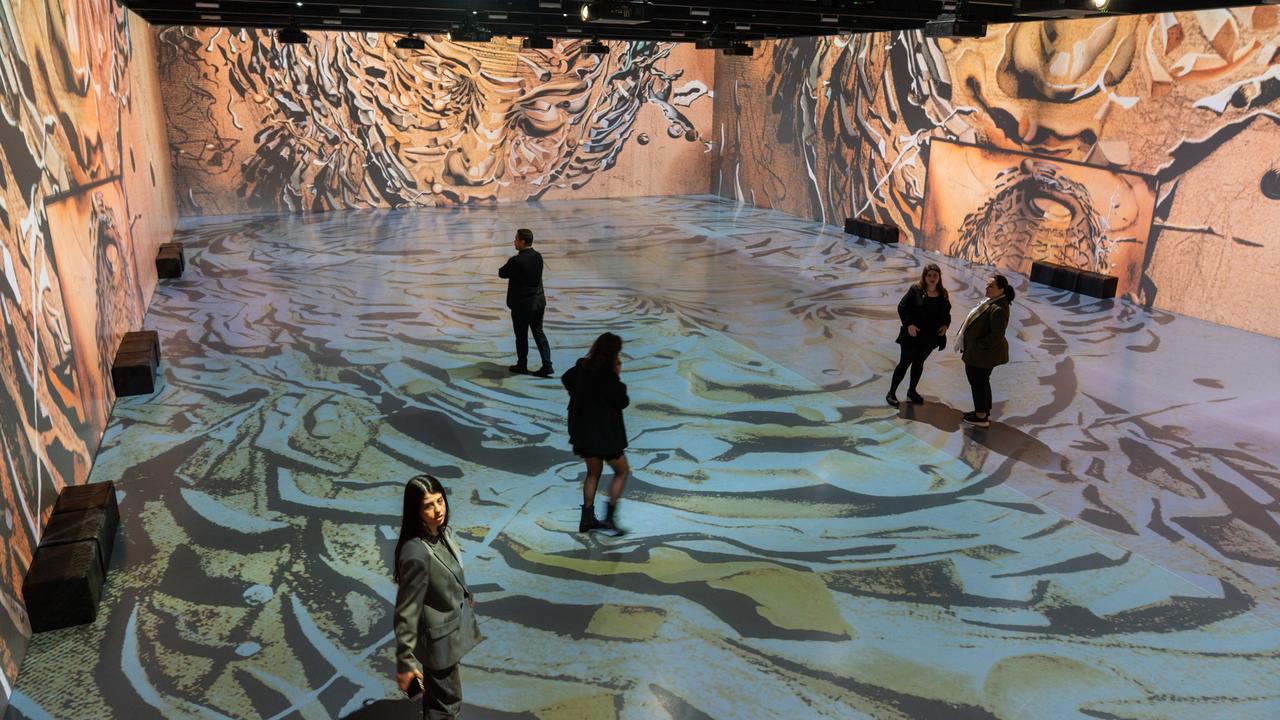 Visitors explore an immersive exhibition featuring large-scale digital projections of Salvador Dali's artworks in Istanbul, Türkiye, Oct. 22, 2026. (AA Photo)