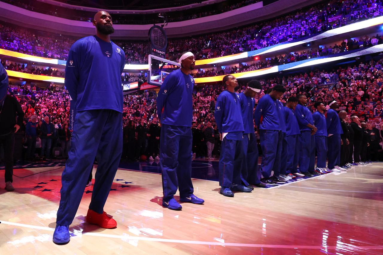 Philadelphia 76ers players, including LeBron James (L), stand on the court before their NBA regular-season game against the Cleveland Cavaliers at Xfinity Mobile Arena in Philadelphia, Pennsylvania, U.S., Oct. 22, 2026. (AFP Photo)