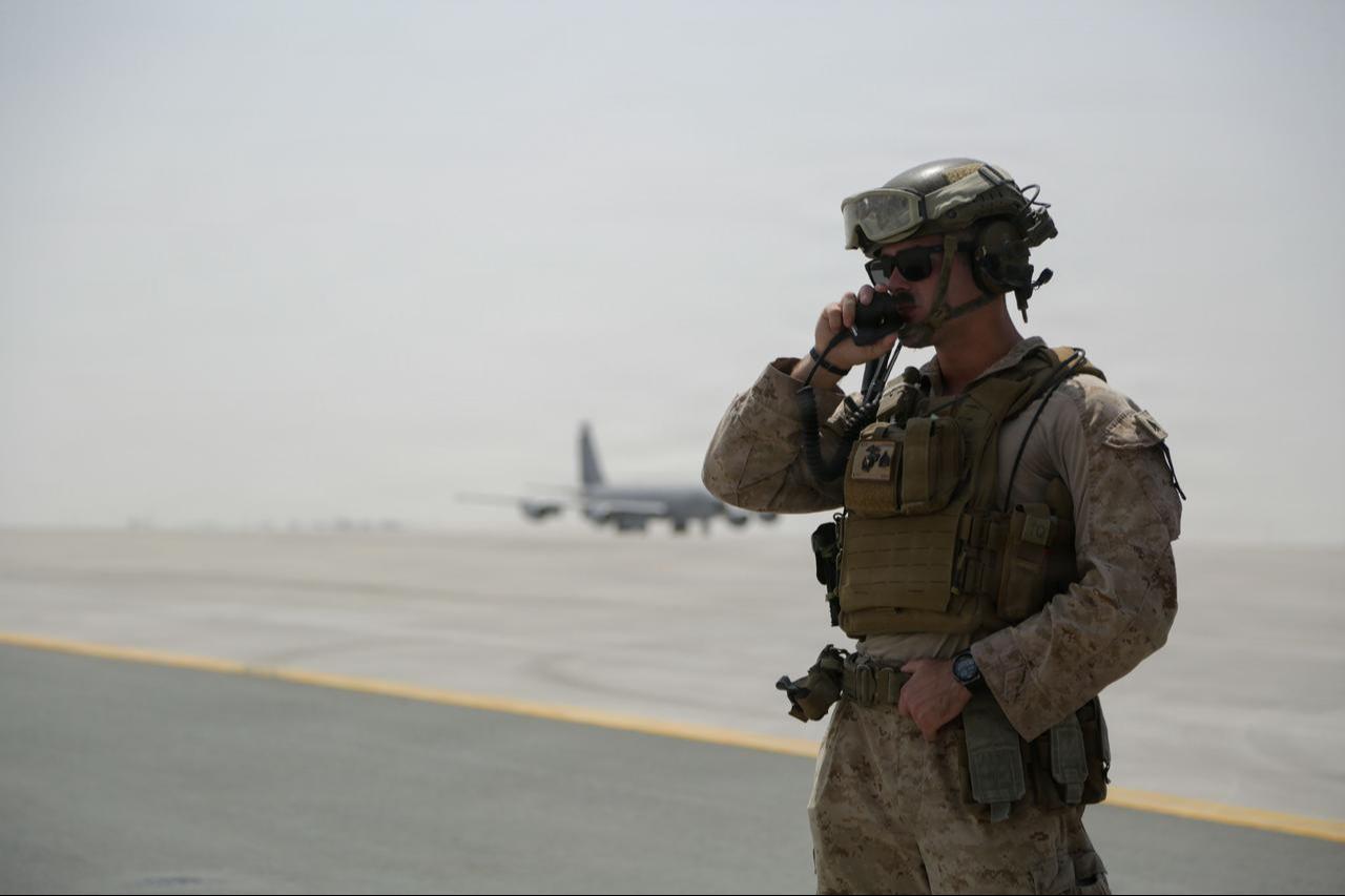 A U.S. Marine communicates over a radio during a forward arming and refueling point in the U.S. Central Command area of responsibility, Sept. 10, 2026. (Photo via U.S. Marine Corps)