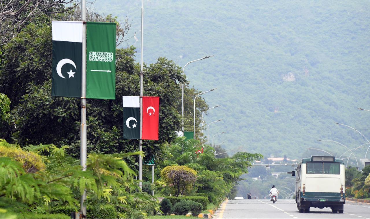 The flags of Türkiye , Pakistan and Saudi Arabia are displayed along a road following the signing of a joint defense agreement among the three countries, in Islamabad, Pakistan, on August 9, 2026. (AA Photo)