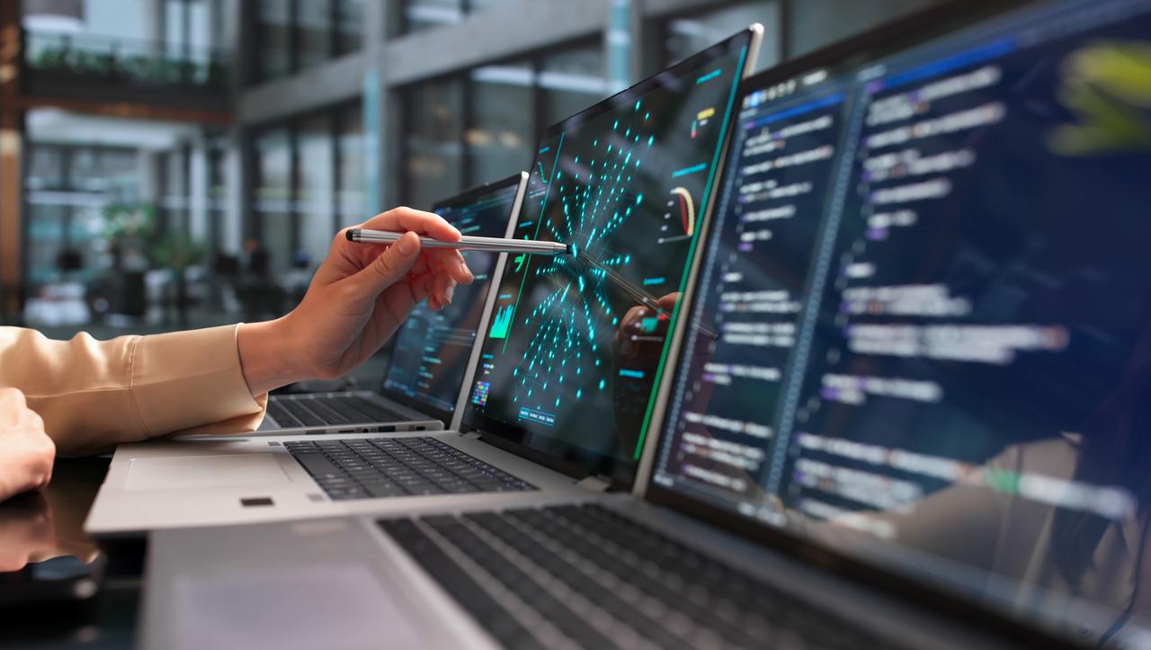 A programmer uses a laptop to analyze neural network models for predictions. (Adobe Stock photo)
