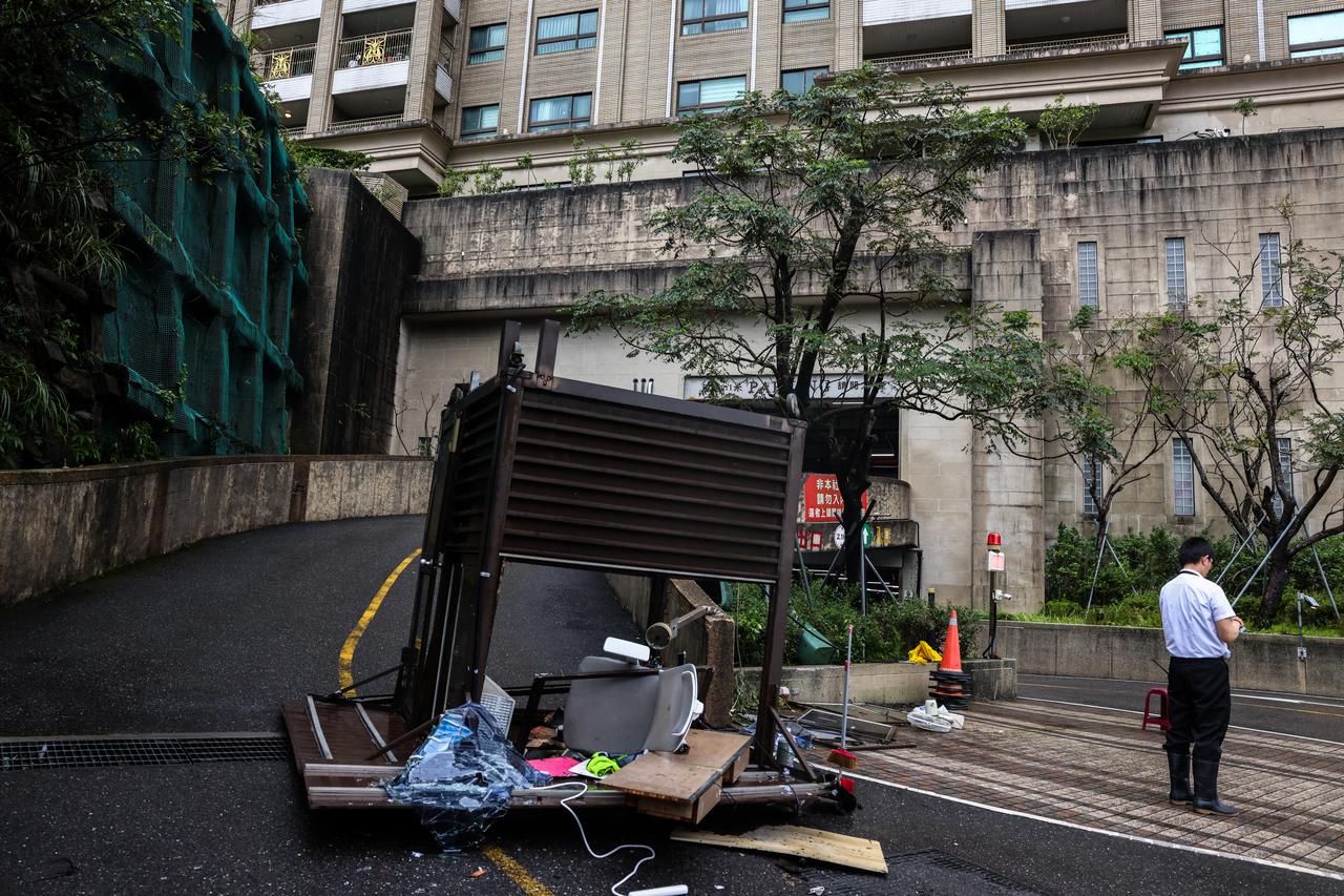 A security guard booth lies toppled after strong winds brought by Typhoon Champi in Keelung on October 24, 2026. (AFP Photo)