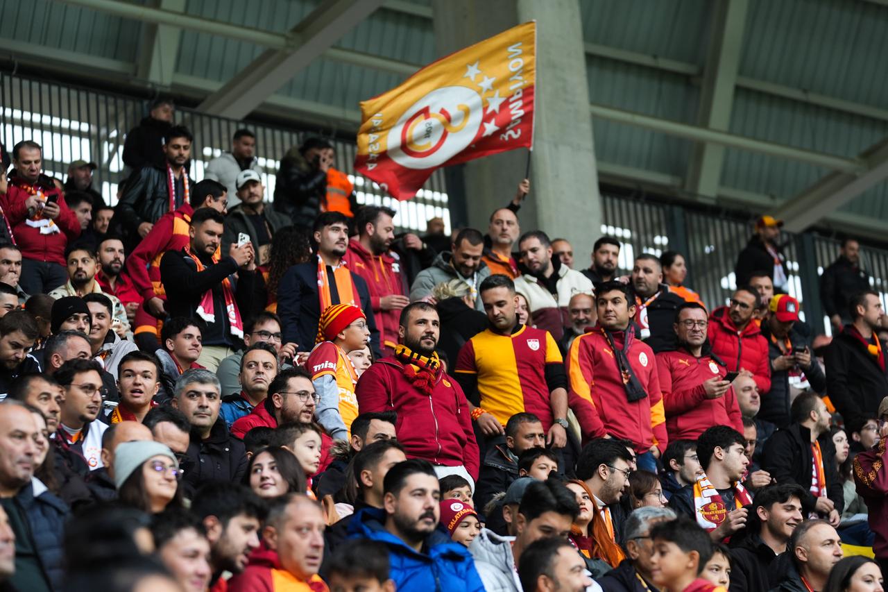 Galatasaray supporters cheer and wave a club flag during the Turkish Super Lig match against Genclerbirligi in Ankara, Türkiye, Oct. 17, 2026. (AA Photo)