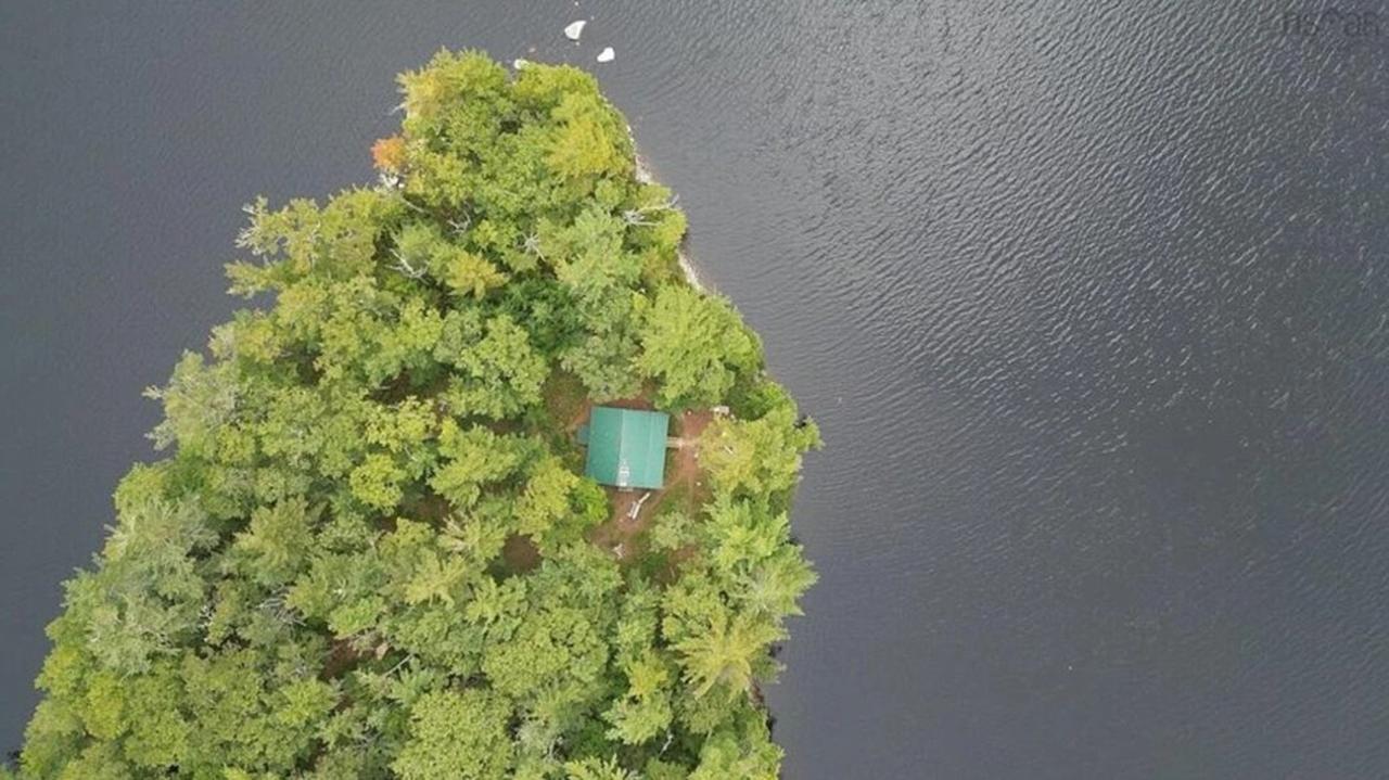 An aerial view shows the tree-covered private island won by Matthias Ross in 2005 and listed for sale 21 years later, in Nova Scotia, Canada. (Photo via Gazete Oksijen)