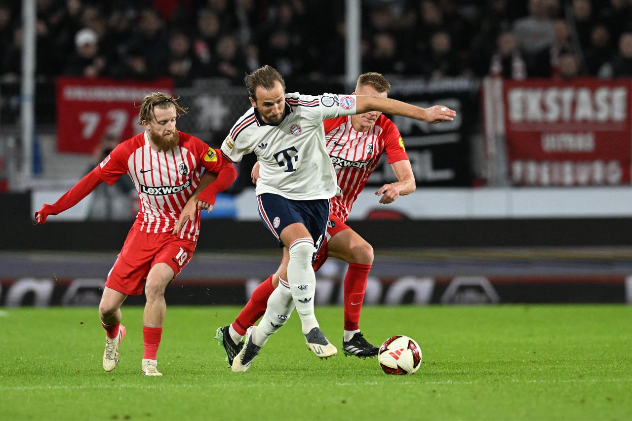 Bayern Munich's English forward #09 Harry Kane (C) vies for the ball with Freiburg's German midfielder #19 Jan-Niklas Beste (L) and Freiburg's Austrian defender #03 Philipp Lienhart (R) during the German first division Bundesliga football match between SC Freiburg and FC Bayern Munich in Freiburg, south-western Germany, on October 25, 2026. (AFP Photo)