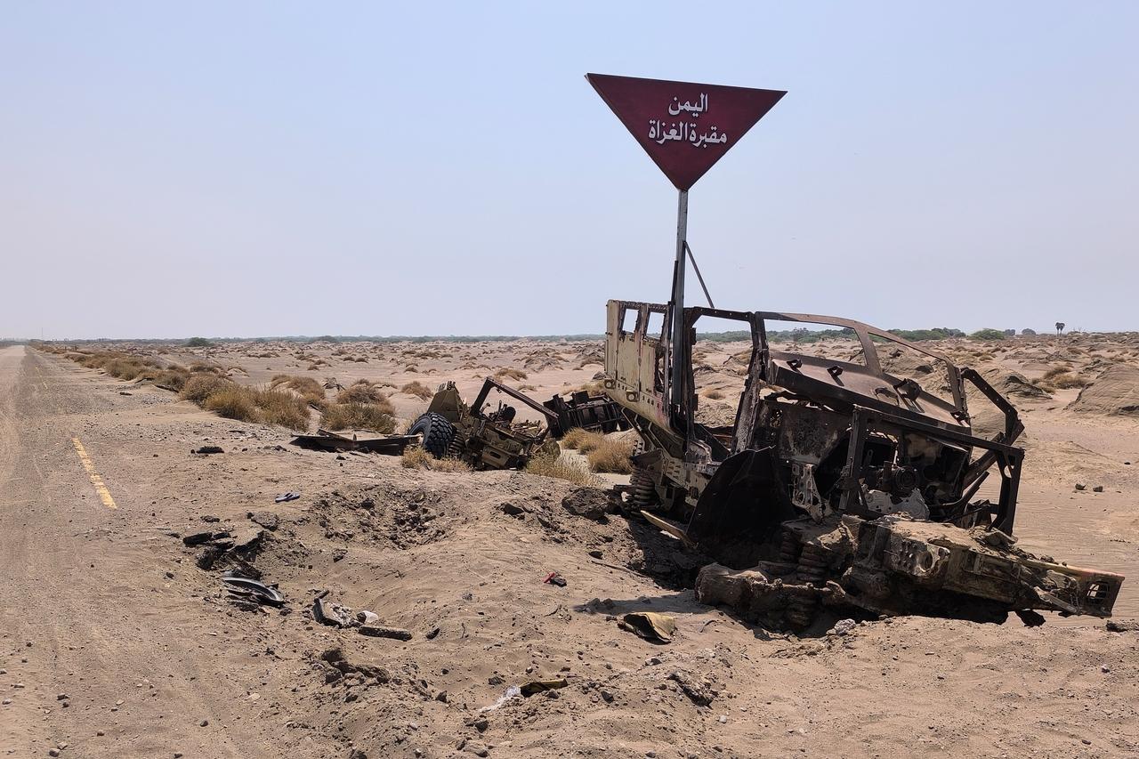 Destroyed military vehicles reportedly belonging to Saudi-backed forces sit along a road following fighting between Houthi fighters and the Saudi-led coalition near Mocha on October 17, 2026. (AFP Photo)