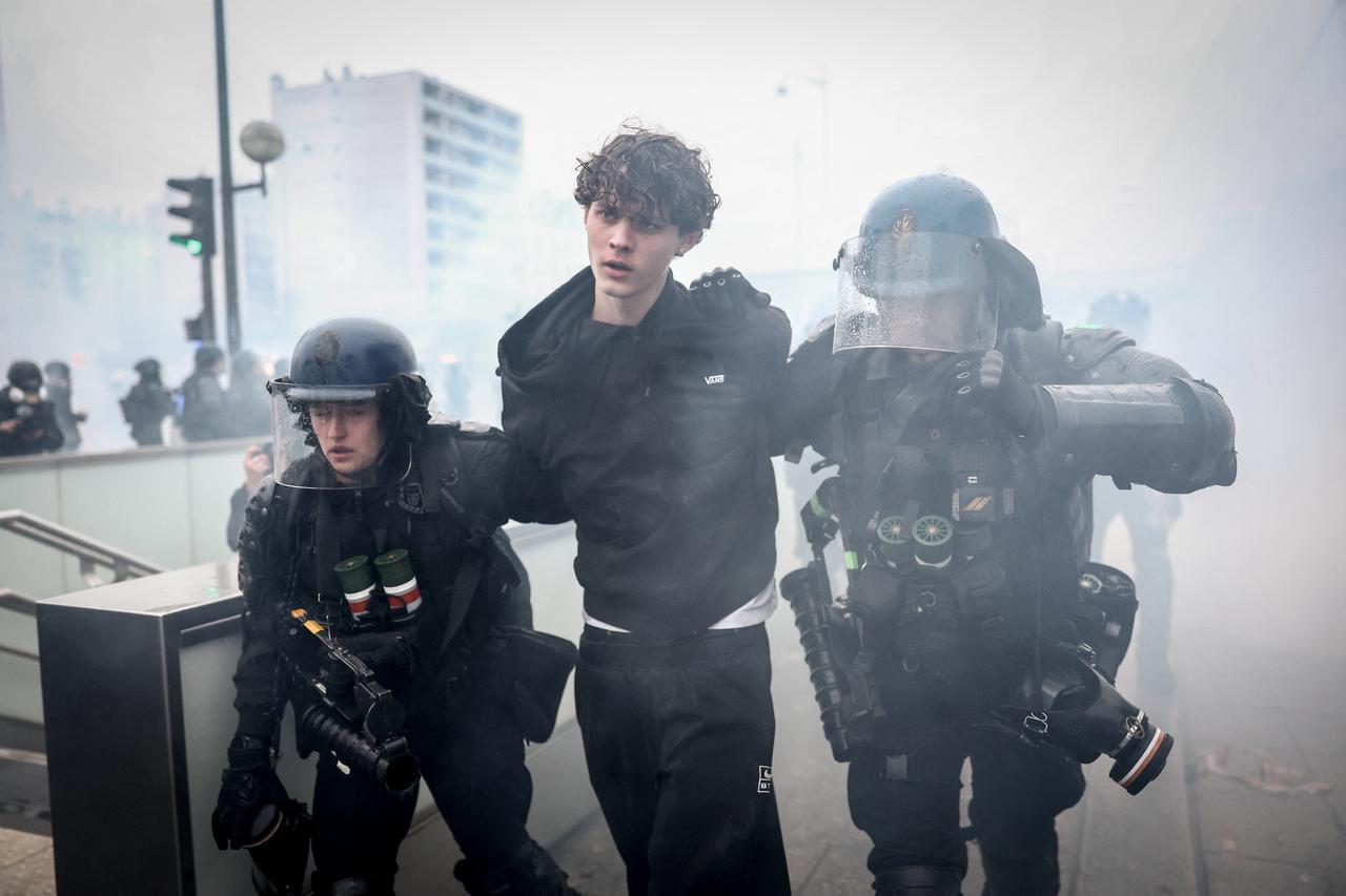 French Gendarmes detain a protester during a demonstration in favor of purchasing power, the protection of public services, and fiscal and social justice, in Paris on Oct. 24, 2026. (AFP Photo)