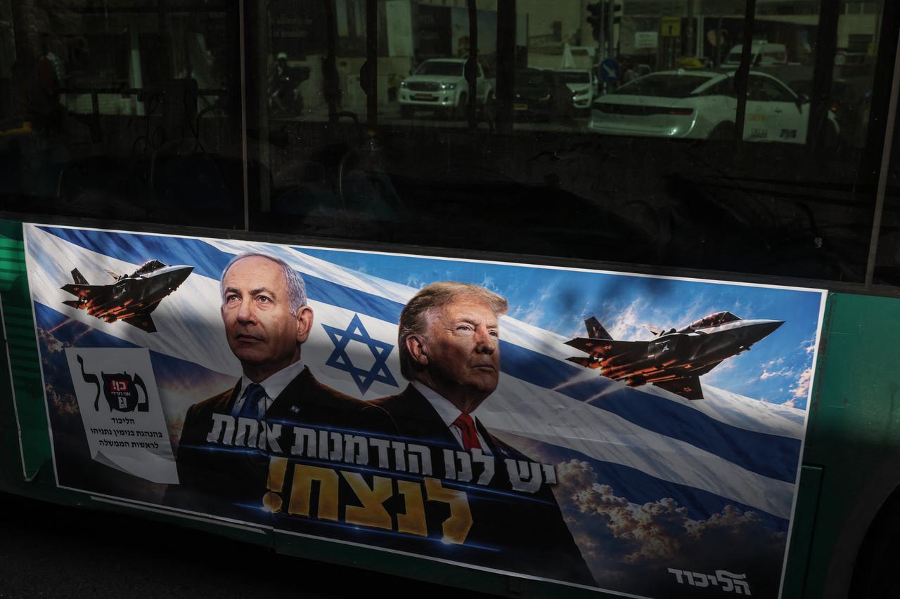 A campaign poster featuring Israeli Prime Minister and Likud party chairman Benjamin Netanyahu alongside US President Donald Trump is displayed on a bus driving through Jerusalem on Oct. 26, 2026. (AFP Photo)
