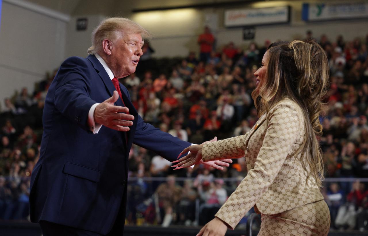 U.S. President Donald Trump welcomes rapper Nicki Minaj onstage during a campaign rally supporting Republican candidates ahead of the midterm elections in Port Huron, Michigan, U.S., Oct. 25, 2026. (AFP Photo)