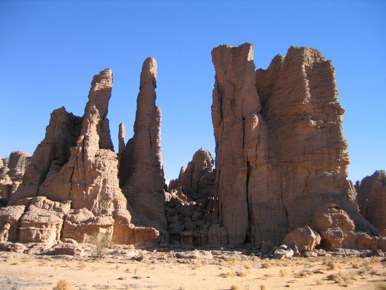 Rock formations rise above the desert landscape in Tassili n'Ajjer, Algeria, Nov. 10, 2004. (Photo by Mohammed Beddiaf)