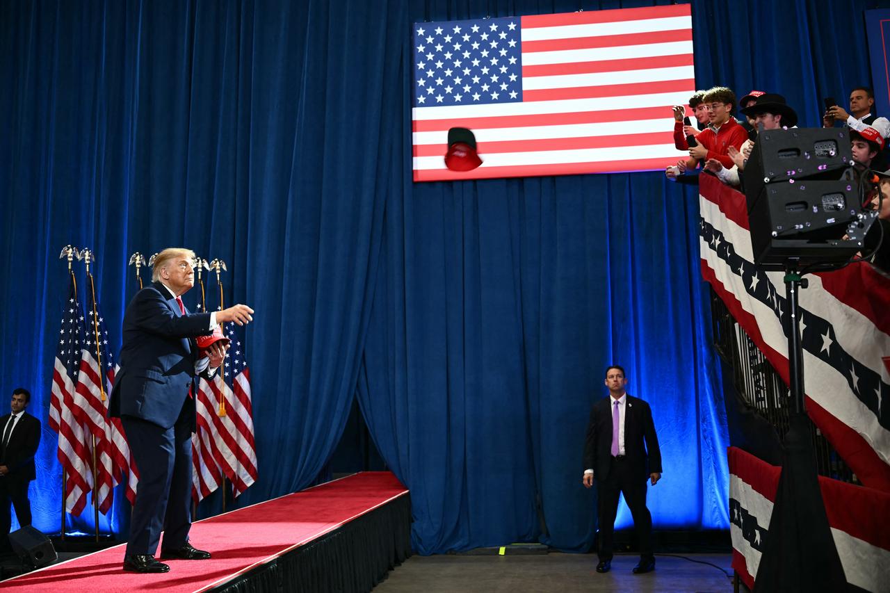 US President Donald Trump throws MAGA hats to supporters during a midterm campaign rally at Lubbock Memorial Civic Center in Lubbock, Texas on October 27, 2026. (AFP Photo)