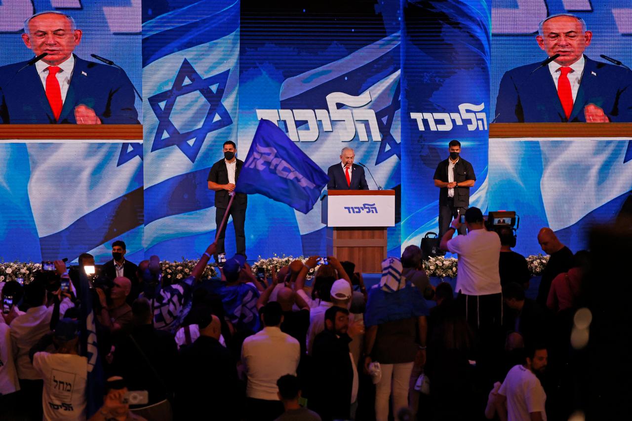 Israel's Prime Minister Benjamin Netanyahu (C) addresses his supporters at the election night rally after the first exit polls were announced, in Jerusalem on early October 28, 2026, during Israel's legislative elections. (AFP Photo)