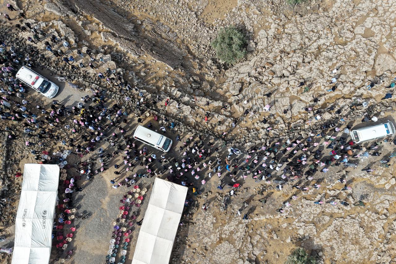This picture shows an aerial view of people attending the funeral of those who were killed in airstrikes carried out by Jordan the night before on the village of Al-Taf in the Al-Lajat region, located in the northeastern countryside of Daraa, on October 27, 2026. (AFP Photo)