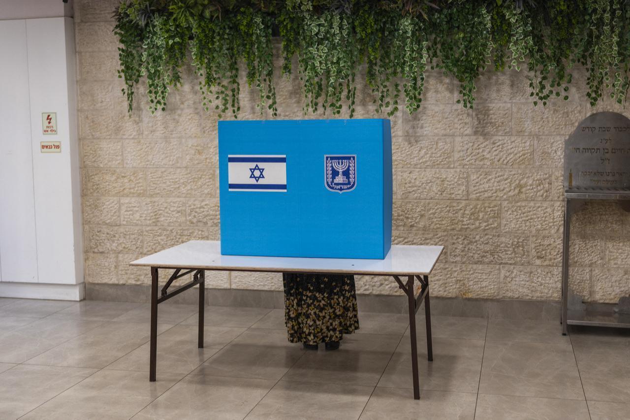 A voter casts her ballot at a polling station in the occupied West Bank city of Hebron on October 27, 2026 during Israel's legislative election. (AFP Photo)