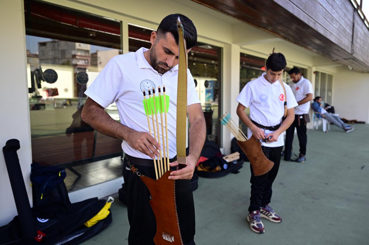 Turkish archer Fatih Cetin checks his arrows alongside teammates at the Okmeydani Archers Foundation facilities ahead of the world championships in Ulsan. (AA Photo)