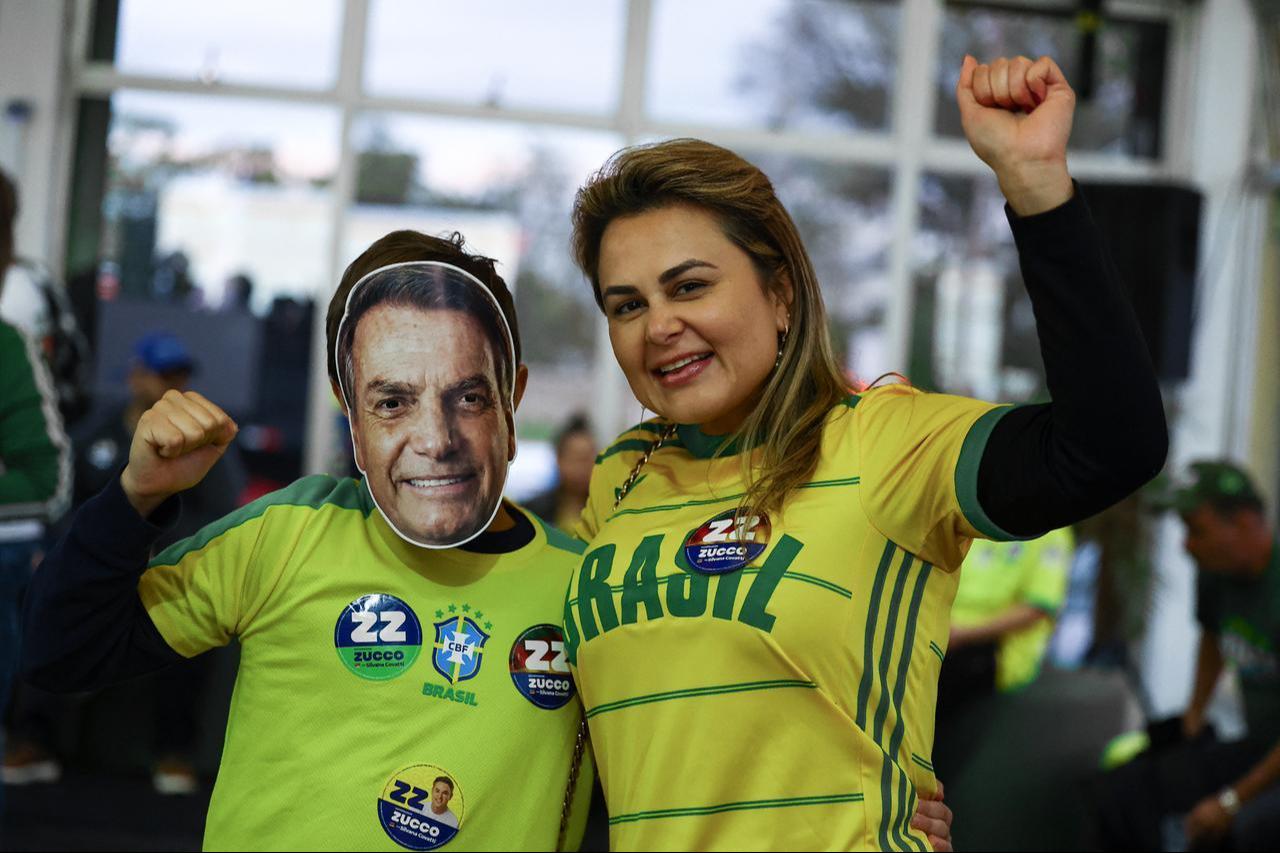 Supporters of Brazil's right-wing presidential candidate Flavio Bolsonaro react as they wait for the first results in in Porto Alegre, Brazil, on October 4, 2026. Brazilians waited anxiously on Oct. 4, 2026. (AFP Photo)