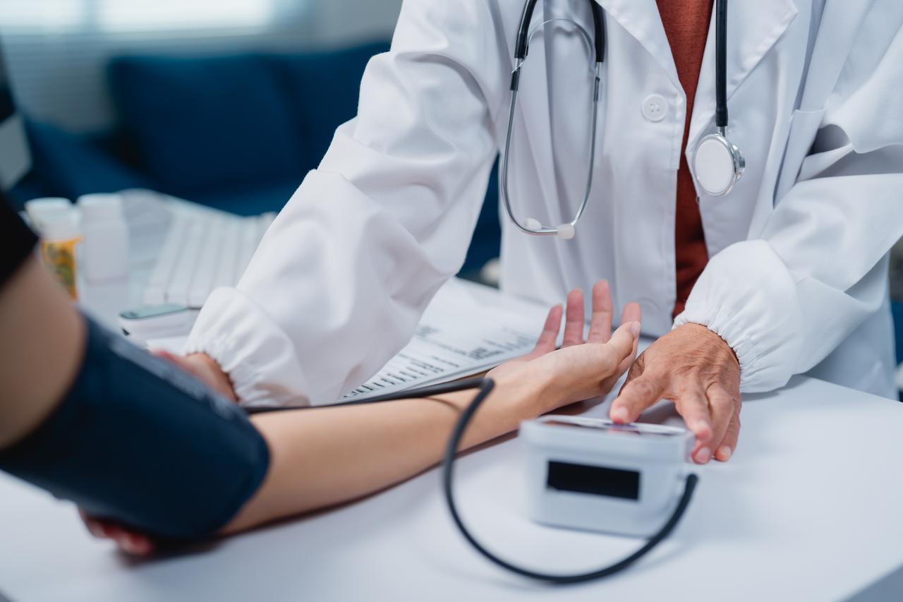 A healthcare professional checks a patient's blood pressure during a medical examination. (Adobe Stock Photo)