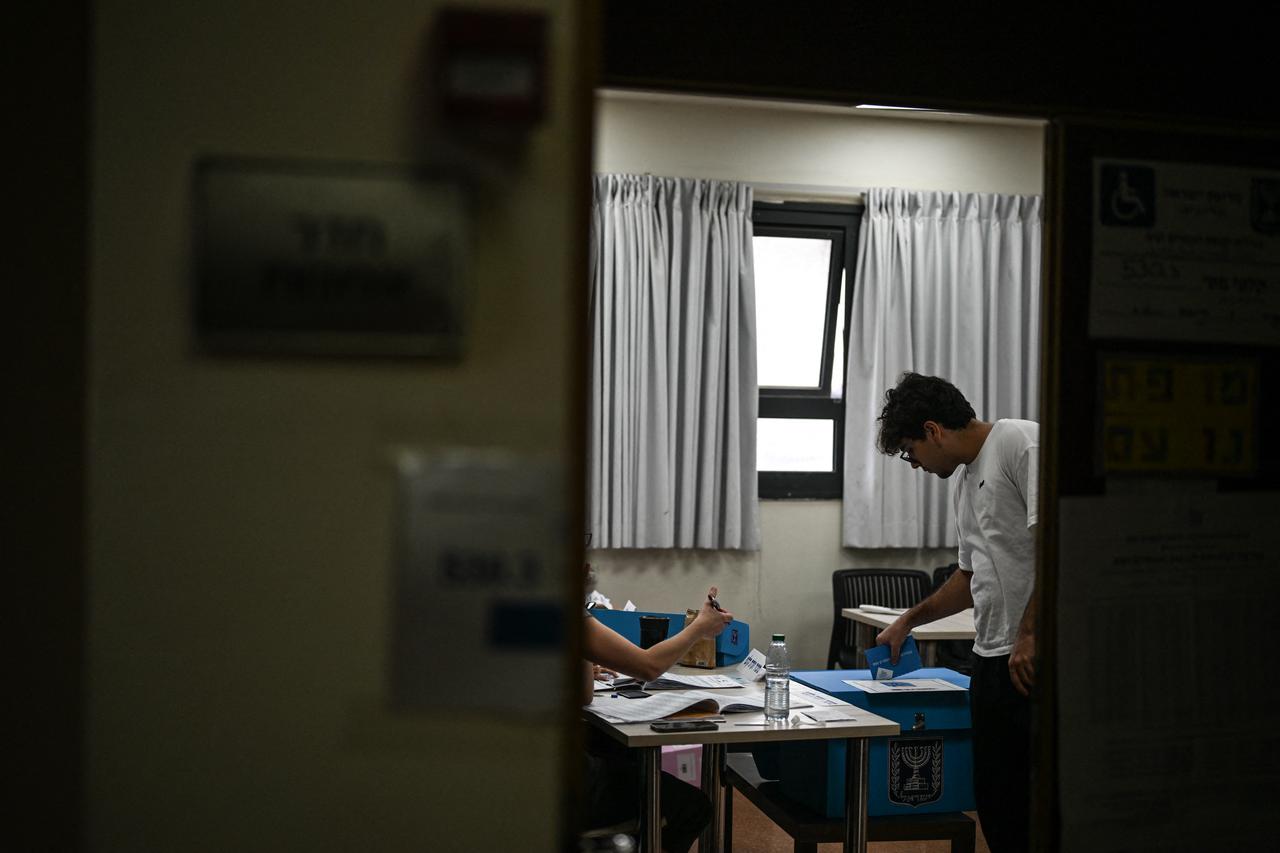 A man casts his vote at a polling station in Jerusalem on October 27, 2026, on the day of Israel's legislative election. (AFP Photo)