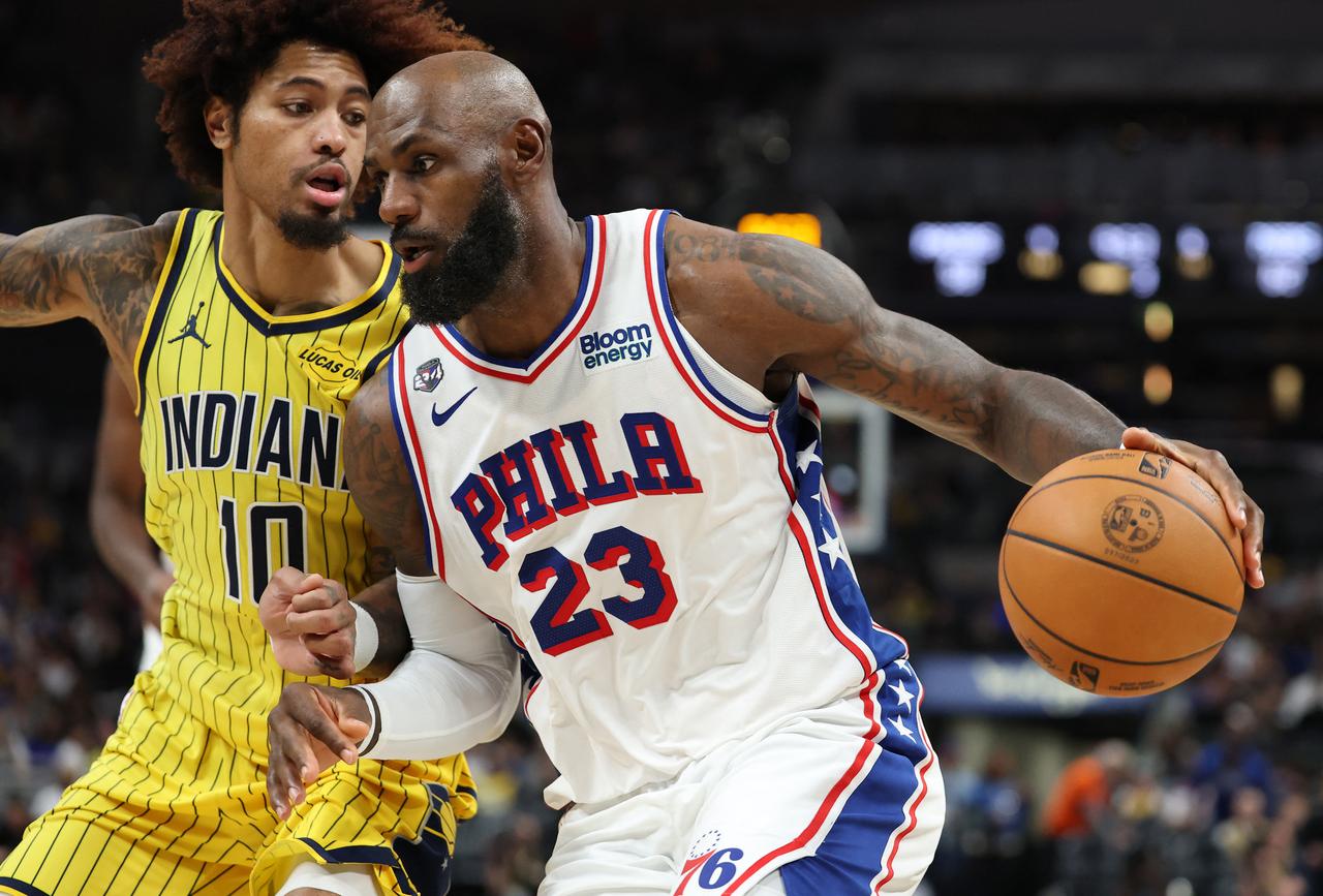 Philadelphia 76ers forward LeBron James is not shown; Philadelphia 76ers player No. 23 drives with the ball against Indiana Pacers player No. 10 during an NBA game. (AFP Photo)