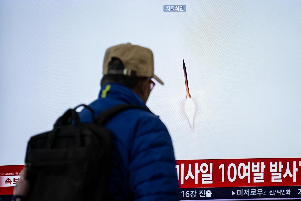 A man walks past a screen showing news coverage with file footage of a North Korean missile launch at Seoul Station in Seoul on October 29, 2026. (AFP Photo)