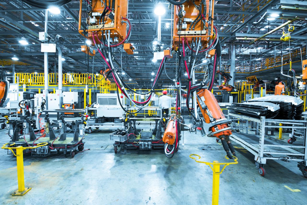 Industrial robotic machinery and automated equipment are pictured inside a manufacturing facility. (Adobe Stock Photo)