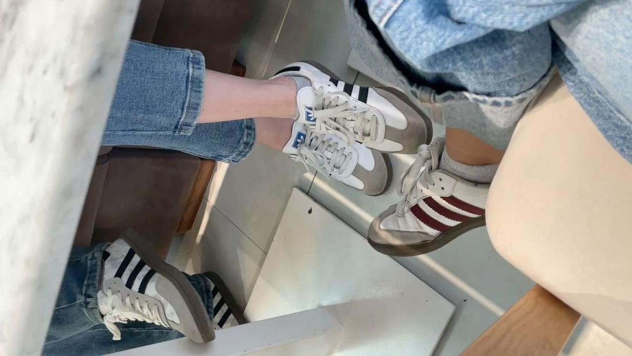 People wear Adidas Samba sneakers while seated together, reflecting the shoe’s popularity in casual fashion. (Photo via Pinterest)