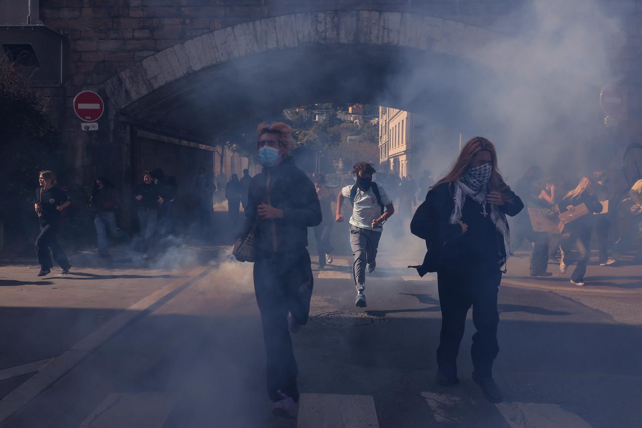 Demonstrators run from tear gas during student protests in Lyon, eastern France on October 2, 2026. (AFP Photo)