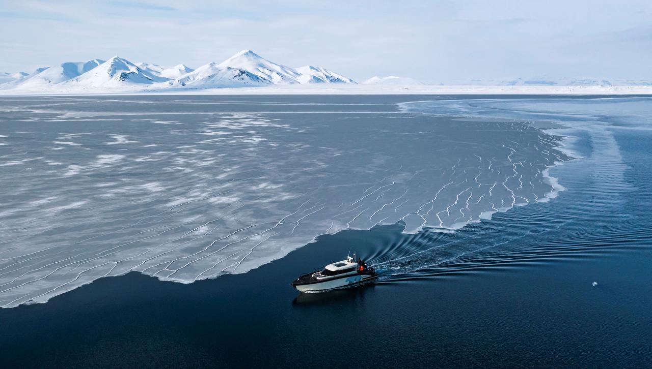 This aerial image, taken on May 3, 2022, shows the Kvitbjorn (Polar Bear in Norwegian), a hybrid tourist boat, moving through the sea ice in Borebukta Bay in the Svalbard Archipelago, northern Norway. (AFP Photo)