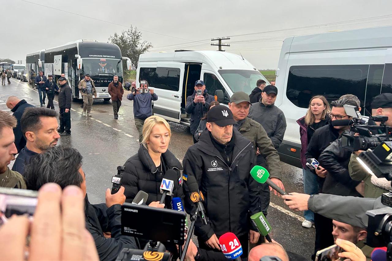 In this handout photograph taken and released on October 30, 2026, Ukraine's Human Rights Commissioner Dmytro Lubinets (2ndL) and Russia's Human Rights Commissioner Yana Lantratova (L) talk to journalists in Armyansk, ahead of the evacuation of local residents from Oleshky. (AFP Photo/Handout/Office of the Ukrainian Ombudsman)