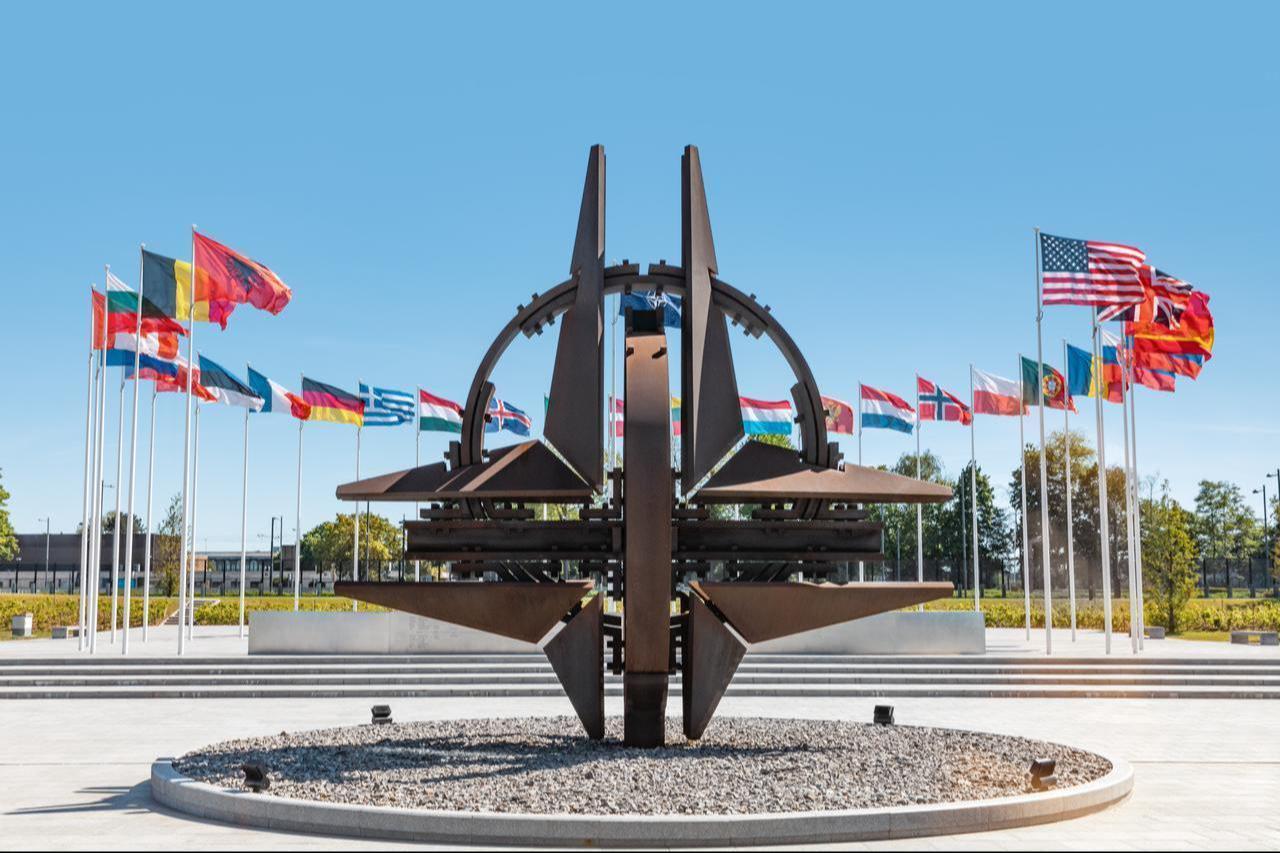 NATO member state flags stand around the NATO Monument at the alliance’s headquarters in Brussels, Belgium, on May 13, 2019. (Adobe Stock Photo)