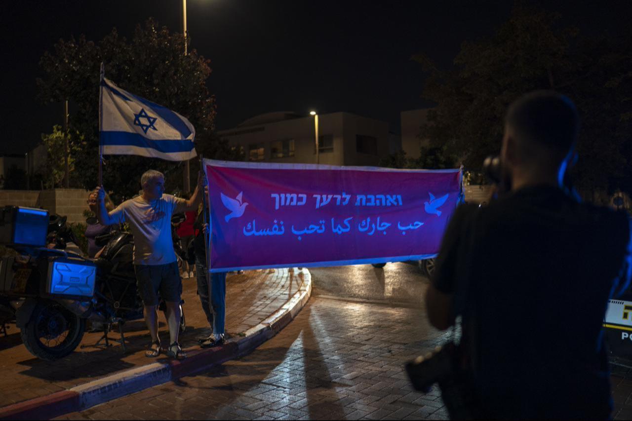 Dozens of demonstrators gather in front of the residence of Gadi Eisenkot, leader of the Yashar Party, to demand the resignation of the right-wing government and the establishment of an Arab-Jewish coalition government in the Herzliya district of Tel Aviv, Israel on Oct. 29, 2026. (AA Photo)