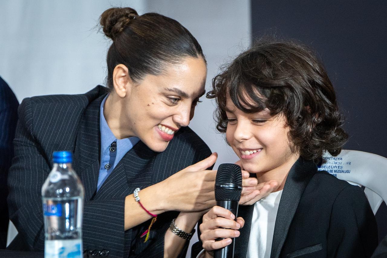 Actress Oyku Karayel shares a moment with young actor Ali Kayra Kul during a discussion about their film "What Remains" at the 63rd International Antalya Golden Orange Film Festival in Antalya, Türkiye, October 2026. (Photo via 63rd International Antalya Golden Orange Film Festival)
