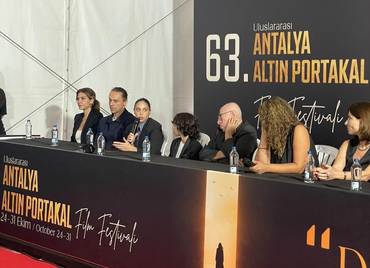 Actress Oyku Karayel speaks during a press conference for "What Remains," alongside director Yesim Ustaoglu and fellow cast members, in Antalya, Türkiye, October 2026. (Photo by Koray Erdogan/Türkiye Today)