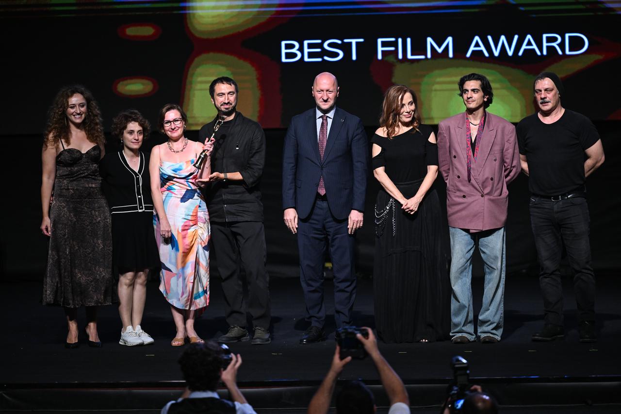 Members of the "Alone Together" team pose after receiving the Best Film Award at the 33rd International Adana Golden Boll Film Festival in Adana, Türkiye, Oct. 3, 2026. (AA Photo)