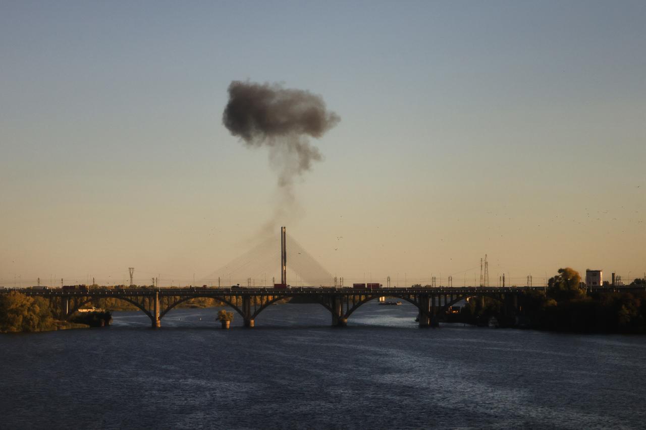 Smoke rises over a bridge spanning the Dnieper River following a drone attack in Kyiv on October 2, 2026. (AFP Photo)