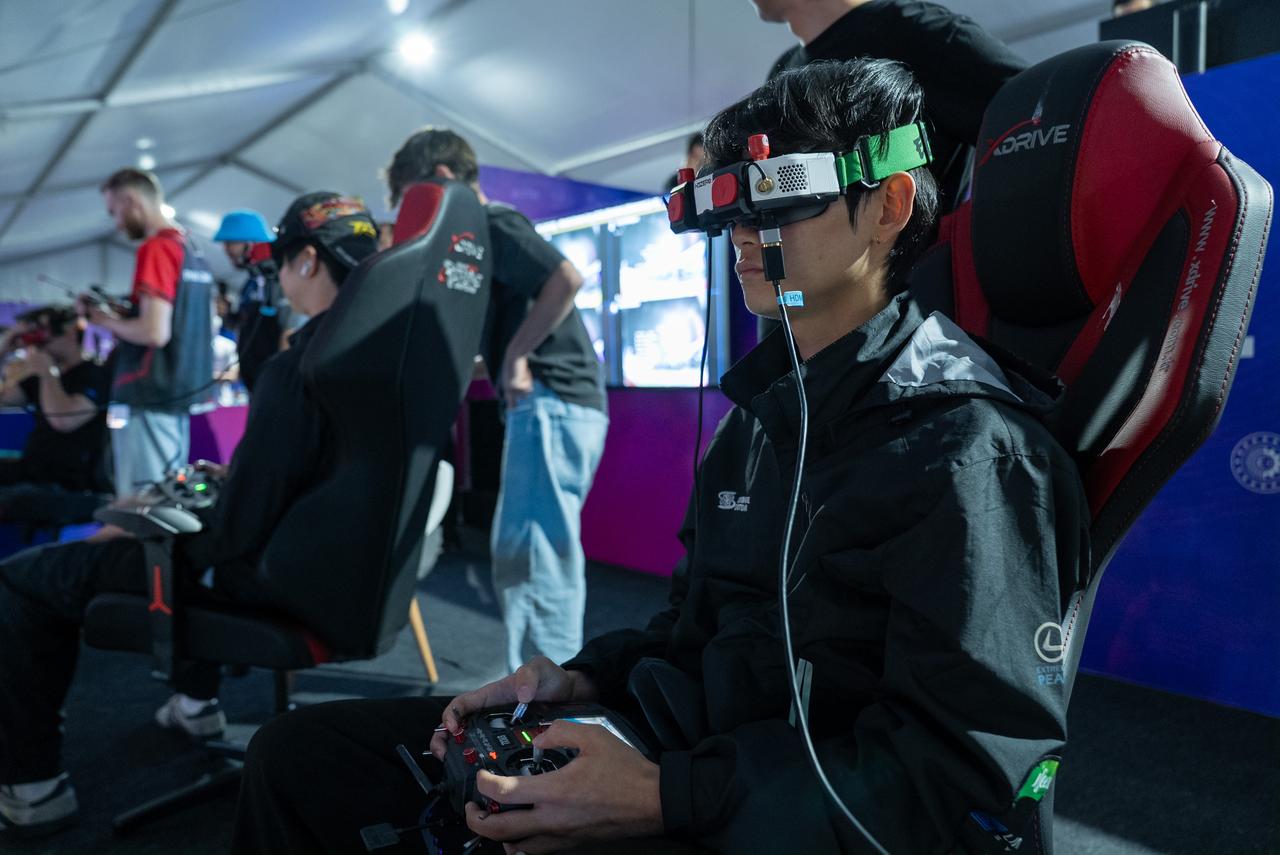 A drone pilot competes using first-person-view (FPV) goggles and a controller during the World Drone Cup at TEKNOFEST Southeast in Sanliurfa, Türkiye, Oct. 3, 2026. (AA Photo)