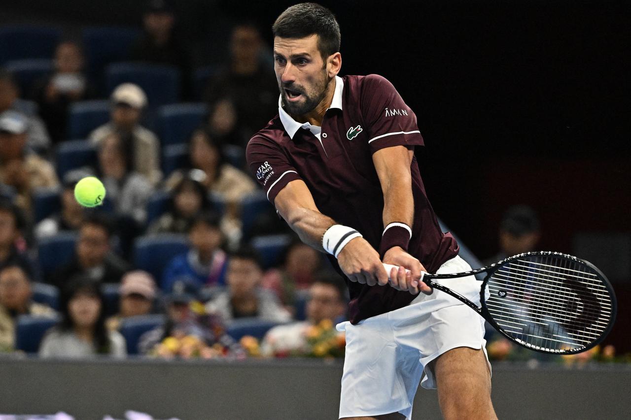 Serbia's Novak Djokovic hits a return to Germany’s Alexander Zverev during their men’s singles quarter-final at the China Open tennis tournament in Beijing on October 4, 2026. (AFP Photo)