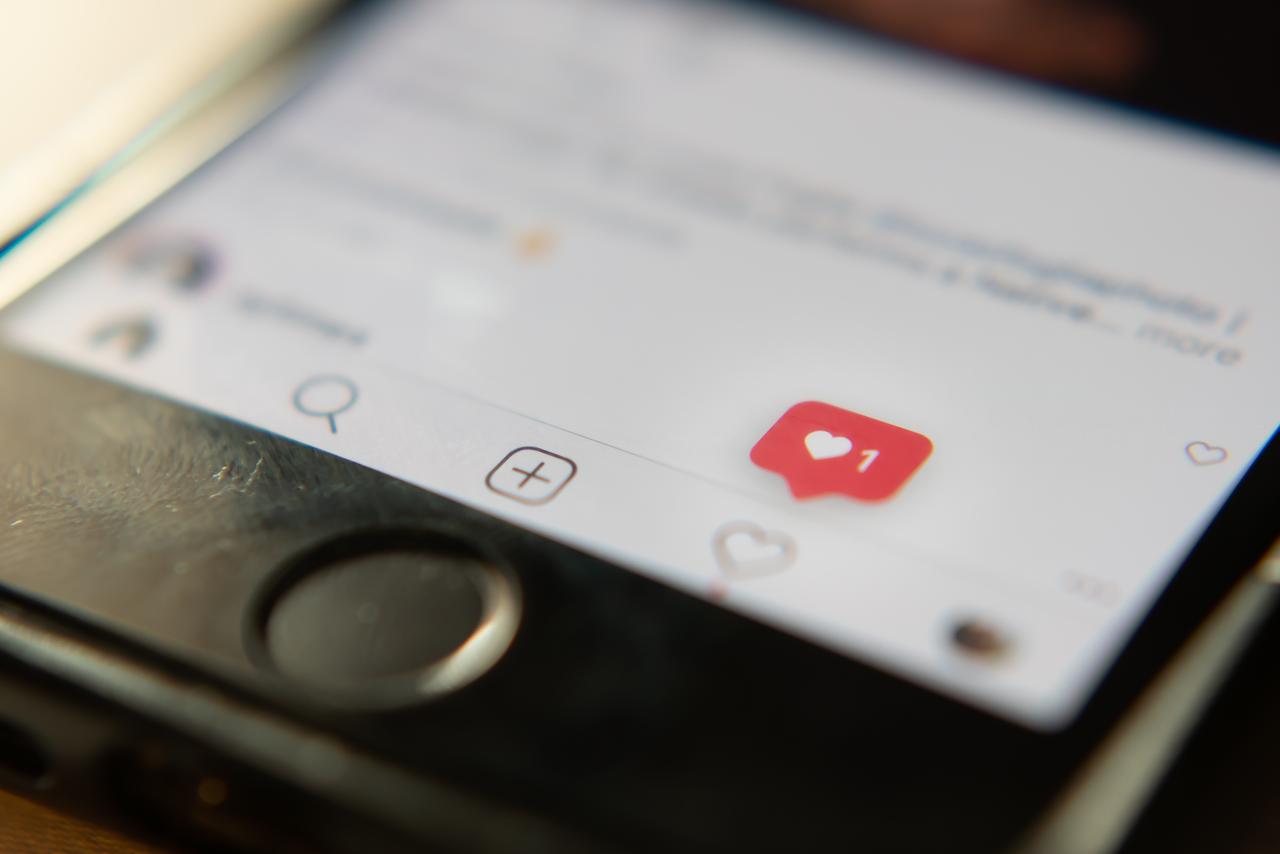An Instagram “like” notification appears on a smartphone screen, illustrating engagement on the social media platform. (Photo via Adobe Stock)