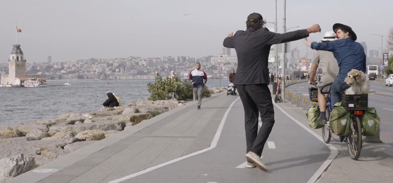 Mathias Mlekuz and Philippe Rebbot cycle along Istanbul's waterfront with the Maiden's Tower visible in the background in a scene from "A Bicyclette!." (Image via M.E.S. Productions, F Comme Film)