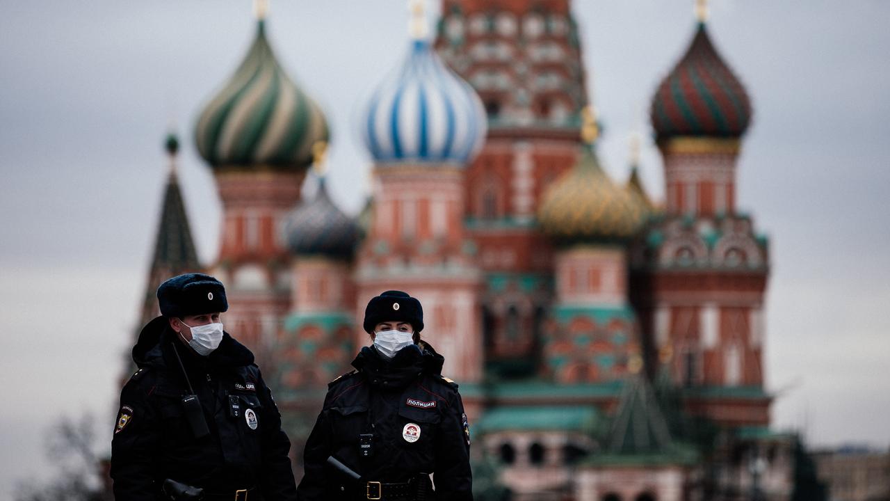 Russian police officers patrol on March 30, 2020, on the deserted Red Square in front of Saint Basil's Cathedral in Moscow, Russia. (AFP Photo)