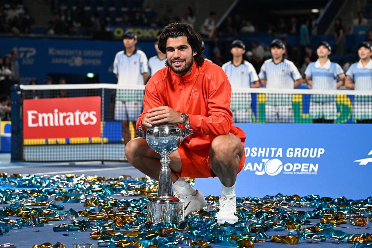 Spain's Carlos Alcaraz celebrates with the trophy after beating the Czech Republic's Jiri Lehecka in the men's singles final during the Japan Open tennis tournament at the Ariake Tennis Forest Park in Tokyo on Oct. 6, 2026. (AFP Photo)