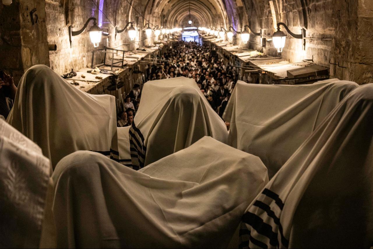 Orthodox Jewish men covered with prayer shawls gather in prayer before the Bab al-Qattanin (Cotton Merchants) gate of the Aqsa compound during morning prayers for Sukkot, in the Old City of Jerusalem, Sept. 28, 2026. (AFP Photo)