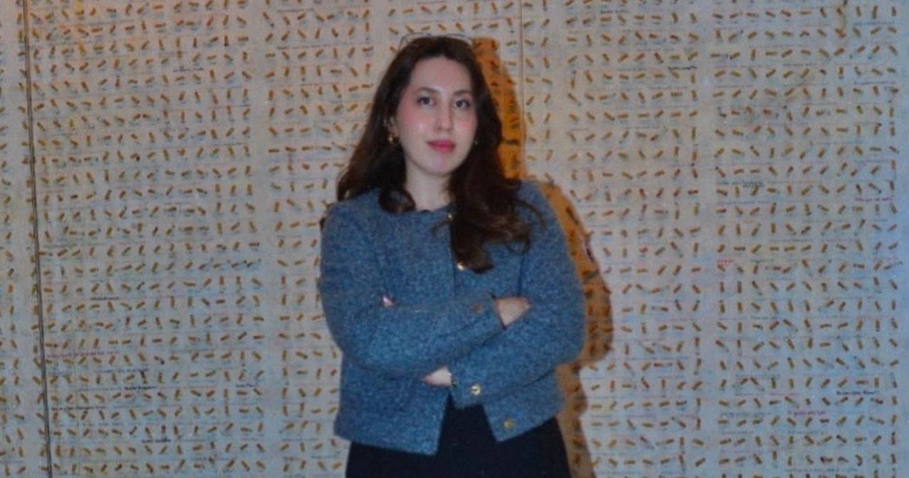 Museum of Innocence manager Gizem Dundar stands beside the cigarette-butt display in Istanbul. (Photo courtesy of Gizem Dundar)