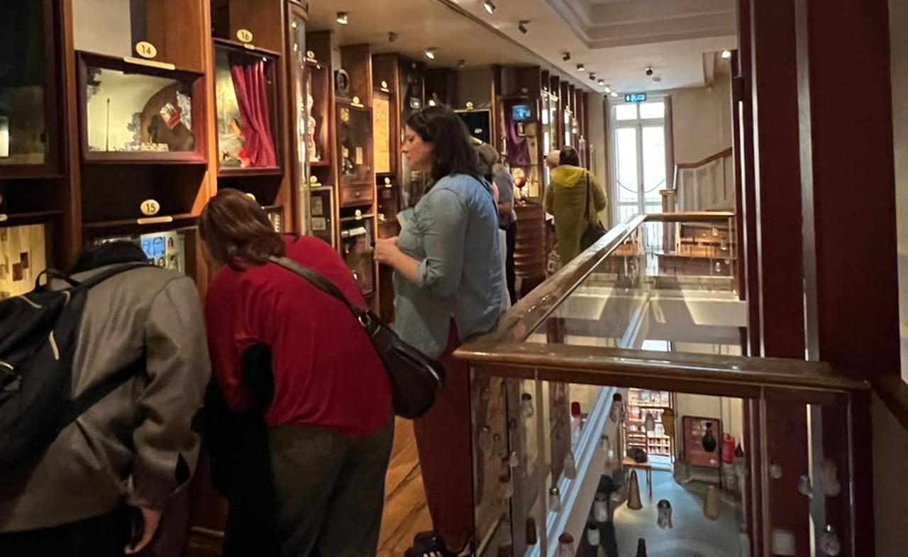 Visitors lean closer to examine display cabinets on an upper floor of the Museum of Innocence. (Photo by Nour Dajani)