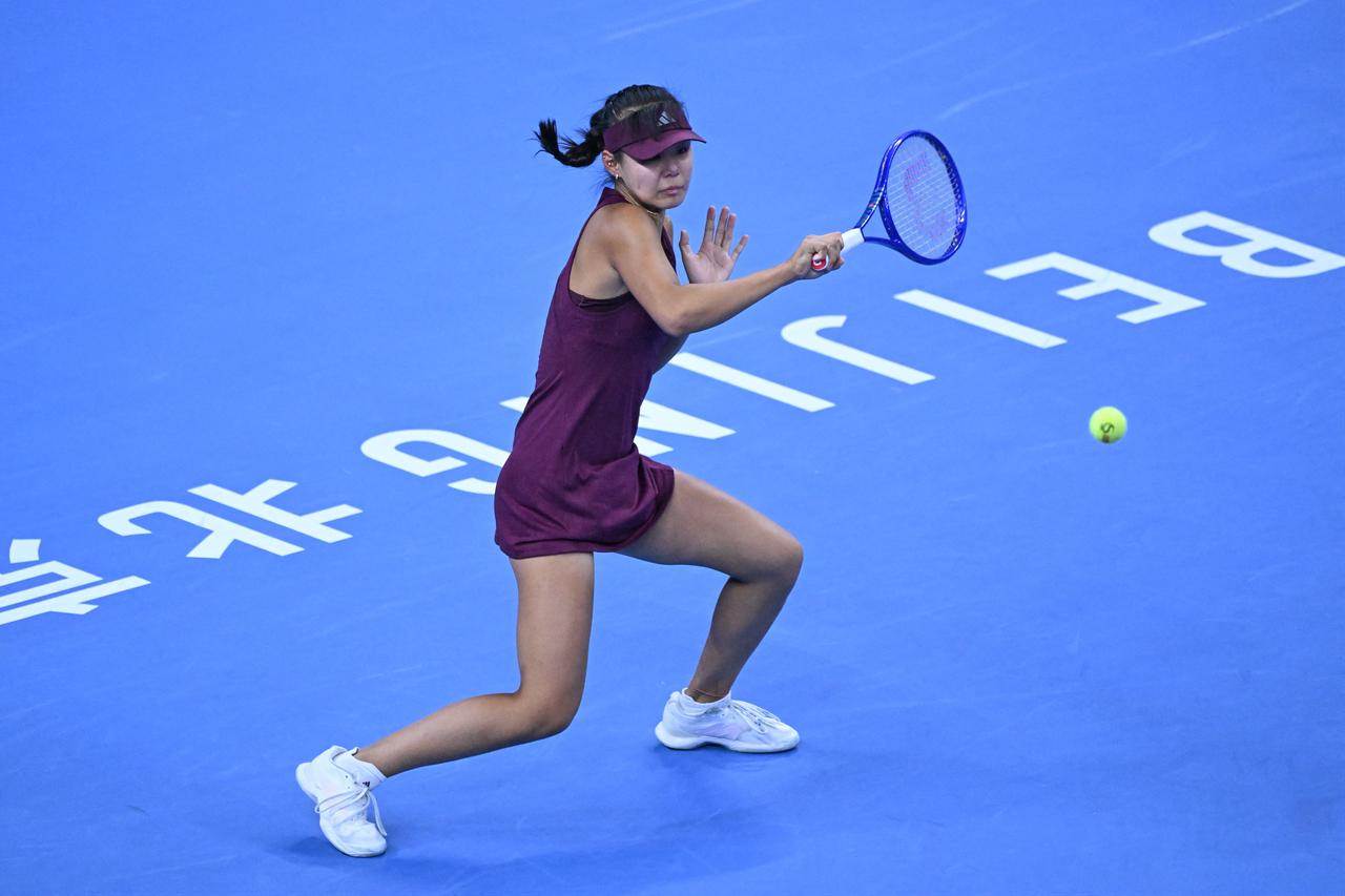 China’s Sun Xinran hits a return to USA's Coco Gauff during their women’s singles match at the China Open tennis tournament in Beijing on October 5, 2026. (AFP Photo)