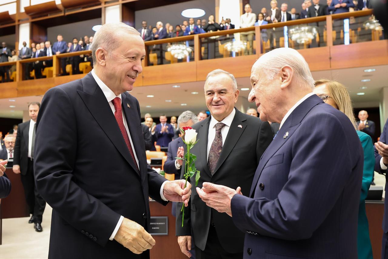 Turkish President Recep Tayyip Erdogan receives red and white rose from Leader of the Nationalist Movement Party (MHP) Devlet Bahceli (R) as he leaves the General Assembly Hall after addressing lawmakers during the opening of the 5th Legislative Year of the 28th Term of the Turkish Grand National Assembly (TGNA) in Ankara, Türkiye, October 1, 2026. ( Turkish Grand National Assembly - Anadolu Agency )