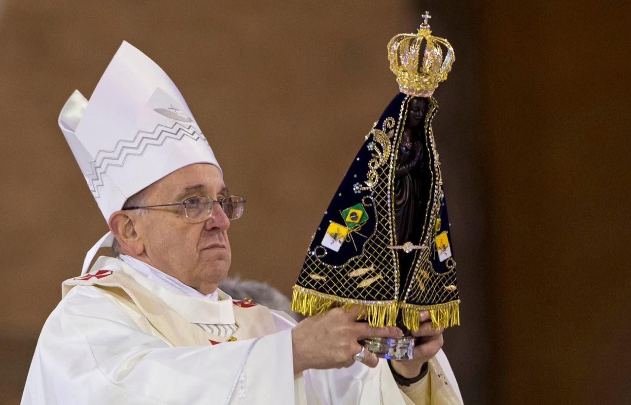 Pope Francis holds a statue of Our Lady of Aparecida, the patron saint of Brazil, during a Mass at the Basilica of the National Shrine of Our Lady of Aparecida in Aparecida, Brazil, July 24, 2013. (Photo via X)