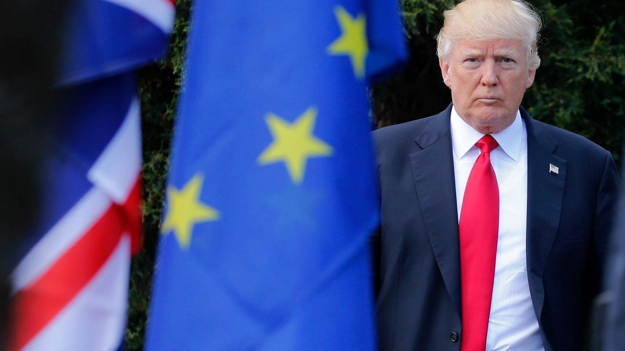 United States President-Elect Donald J. Trump standing next to an European Union Flag. (AFP Photo)