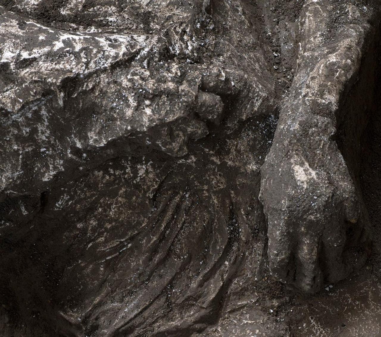 A close-up reveals impressions of clothing and body details preserved on one of Pompeii's casts. (Photo via The Archaeological Park of Pompeii)